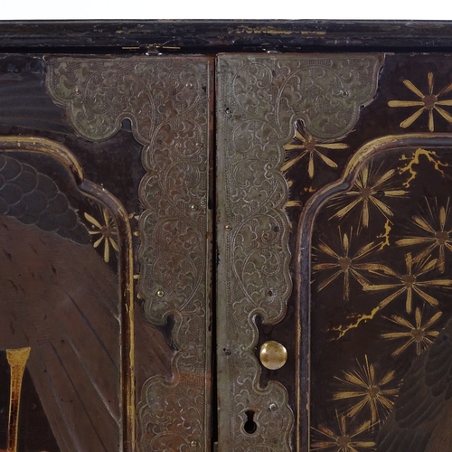 3 - A Japanese Meiji period gilded and lacquered table cabinet with eagle decorated panelled doors, encl... 