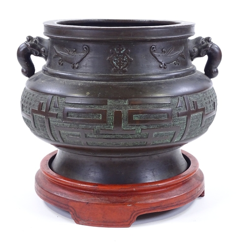 5 - A Chinese bronze incense burner, cast dragon design handles, with relief decorated frieze, rim diame... 