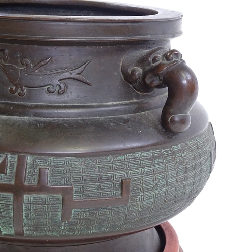 5 - A Chinese bronze incense burner, cast dragon design handles, with relief decorated frieze, rim diame... 