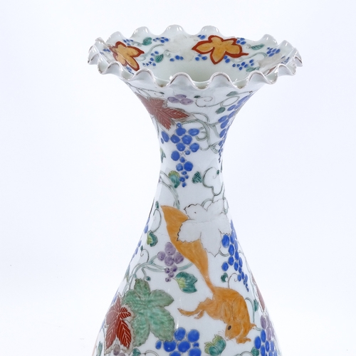 69 - A Japanese porcelain vase with painted enamel decoration, inscribed under base, height 38cm, rim A/F