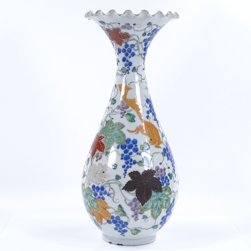 69 - A Japanese porcelain vase with painted enamel decoration, inscribed under base, height 38cm, rim A/F