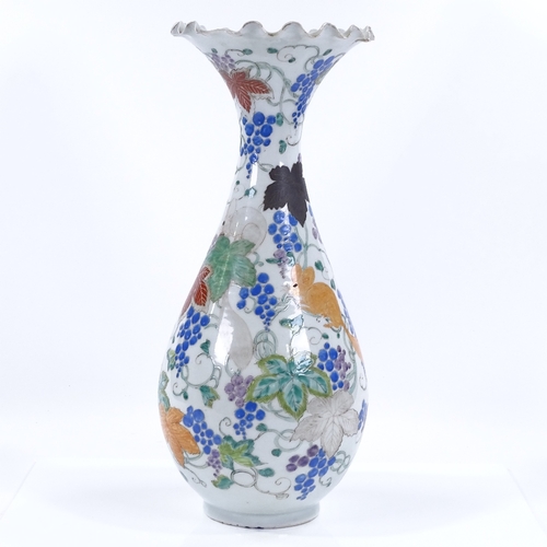 69 - A Japanese porcelain vase with painted enamel decoration, inscribed under base, height 38cm, rim A/F