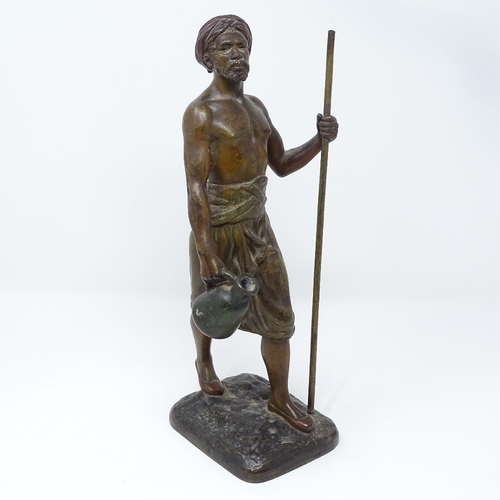 72 - A patinated spelter figure of an Arab man carrying a water flagon, signed on the base, circa 1900, h... 