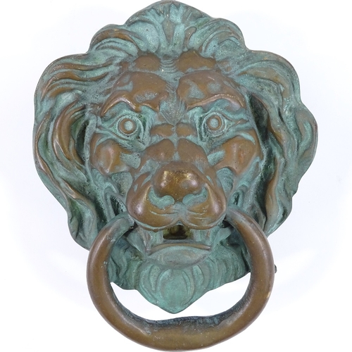 80 - A large cast-bronze lion mask design door knocker, height 25cm