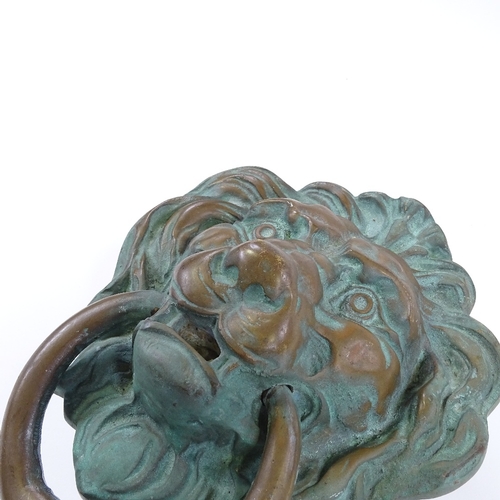 80 - A large cast-bronze lion mask design door knocker, height 25cm