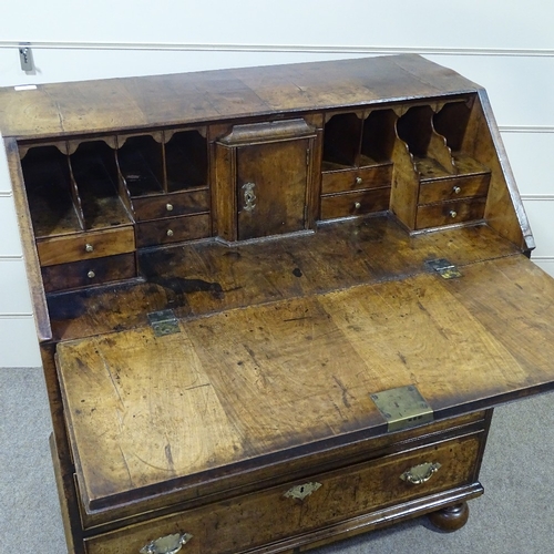 232 - A fine 18th century walnut bureau, with elaborate stepped and drawer fitted interior, 4 long feather... 