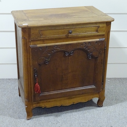 234 - A French cherrywood cupboard, with frieze drawer and carved panelled cupboard below, width 2'10