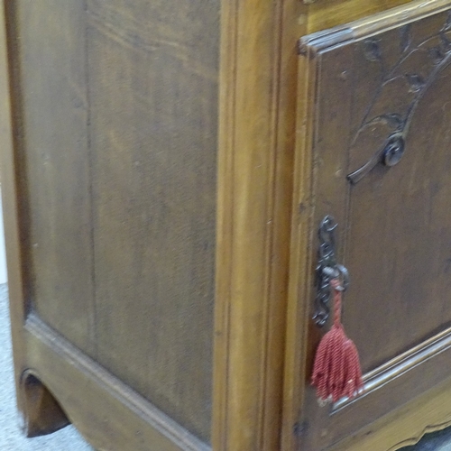 234 - A French cherrywood cupboard, with frieze drawer and carved panelled cupboard below, width 2'10