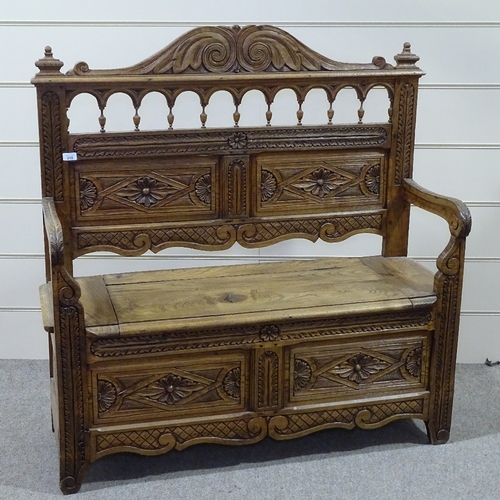 235 - A Victorian light oak hall settle with carved and panelled Arcadian back, length 3'11