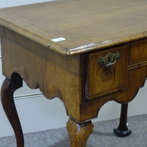 247 - An 18th century walnut lowboy with feather-banded top, 3 frieze drawers with shaped apron and cabrio... 