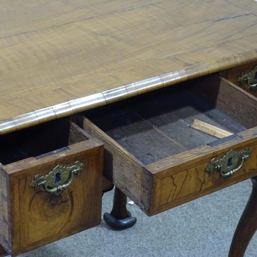 247 - An 18th century walnut lowboy with feather-banded top, 3 frieze drawers with shaped apron and cabrio... 