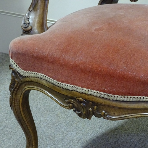 249 - A pair of 19th century walnut-framed armchairs, with all over carved decoration