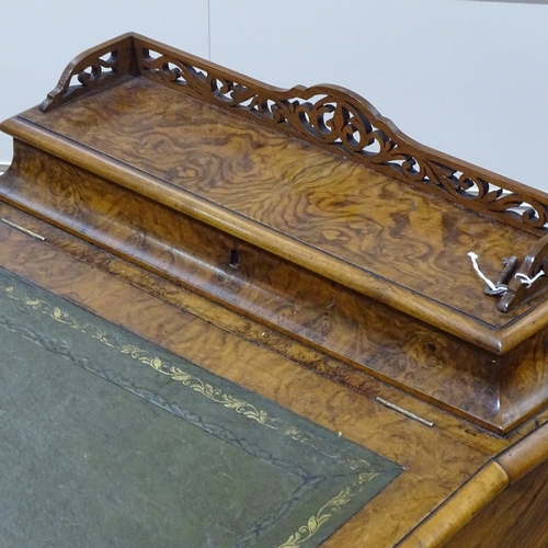 253 - A Victorian walnut Davenport with carved cabriole supports