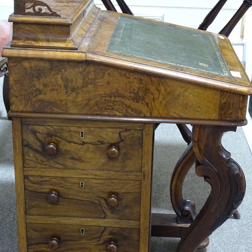 253 - A Victorian walnut Davenport with carved cabriole supports