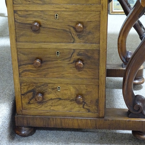 253 - A Victorian walnut Davenport with carved cabriole supports