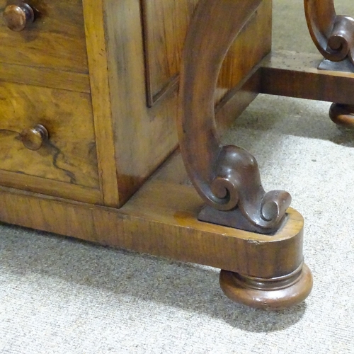 253 - A Victorian walnut Davenport with carved cabriole supports