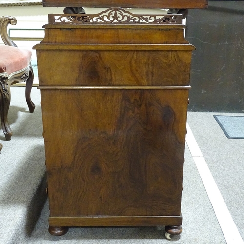 253 - A Victorian walnut Davenport with carved cabriole supports