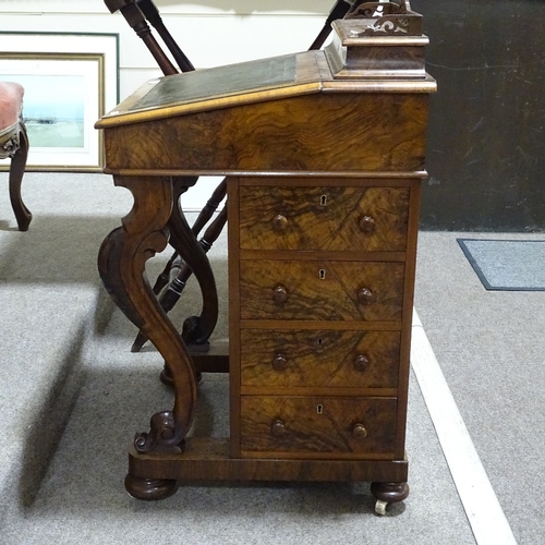 253 - A Victorian walnut Davenport with carved cabriole supports