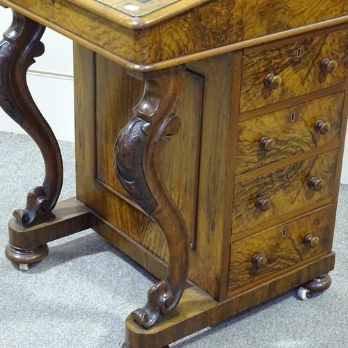 253 - A Victorian walnut Davenport with carved cabriole supports