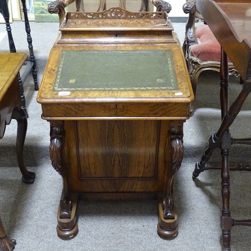 253 - A Victorian walnut Davenport with carved cabriole supports