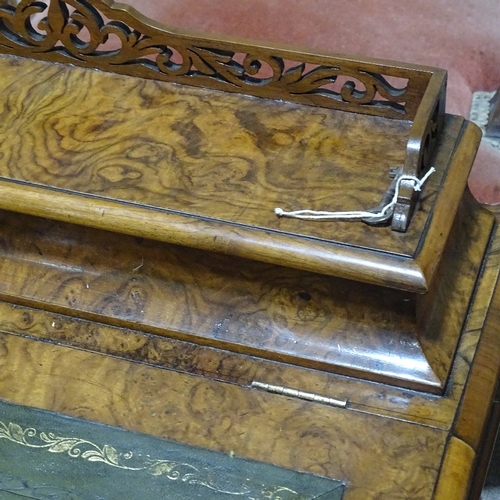 253 - A Victorian walnut Davenport with carved cabriole supports