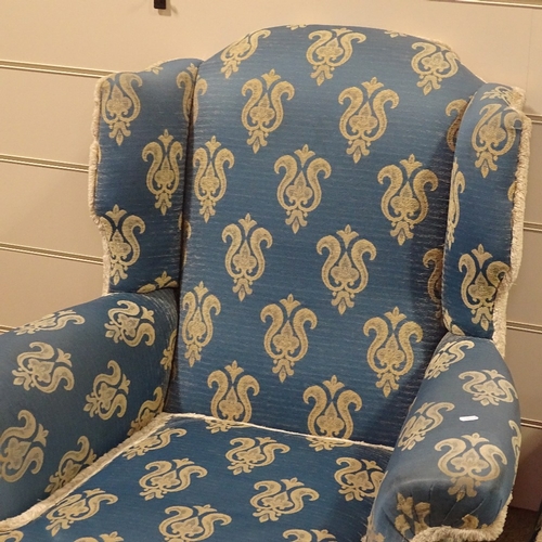 254 - A pair of Queen Anne style upholstered wing armchairs