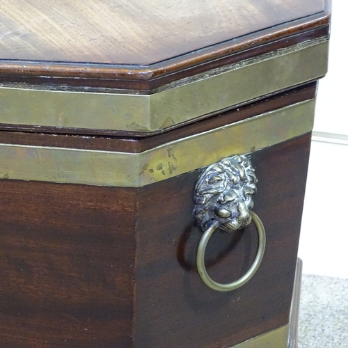 255 - A George III brass-bound mahogany wine cooler of octagonal form, on tapered legs, with brass lion ri... 