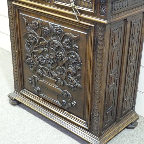 256 - An Antique Flemish oak cupboard, high relief floral carved and panelled doors, with 2 central frieze... 