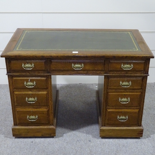 257 - A Victorian oak pedestal desk, with green leather top and brass drop handles, 3'6