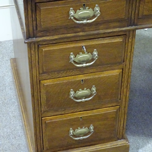 257 - A Victorian oak pedestal desk, with green leather top and brass drop handles, 3'6