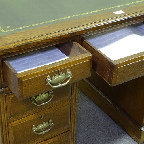 257 - A Victorian oak pedestal desk, with green leather top and brass drop handles, 3'6