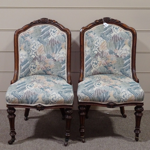 259 - A pair of Victorian carved walnut-framed upholstered chairs