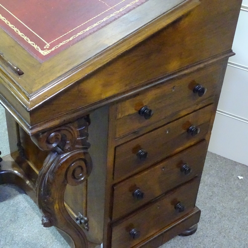 262 - A 19th century rosewood Davenport with carved scroll supports