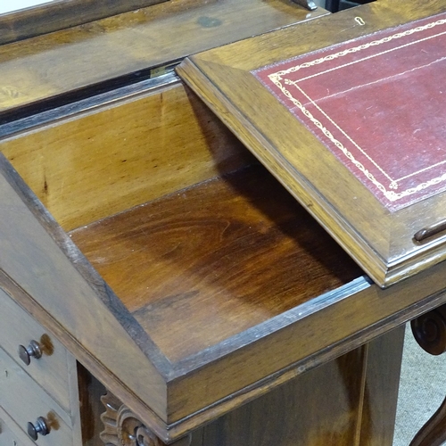 262 - A 19th century rosewood Davenport with carved scroll supports