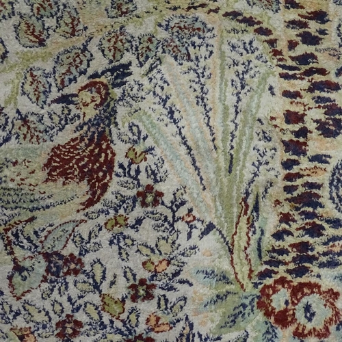 280 - A large oriental silk rug, with exotic bird decoration