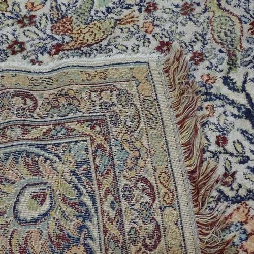 280 - A large oriental silk rug, with exotic bird decoration