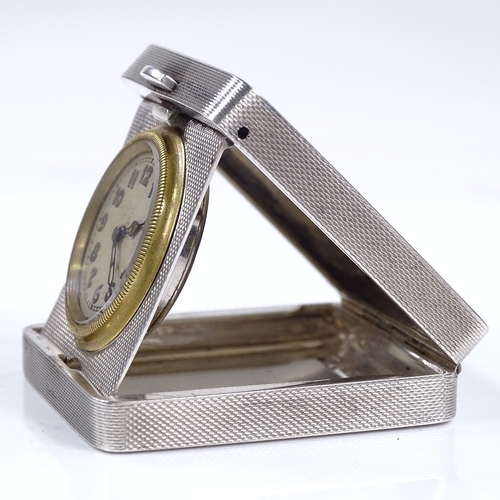 323 - An Art Deco silver-cased travelling timepiece, engine turned case, with Arabic numerals and blued st... 