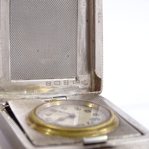 323 - An Art Deco silver-cased travelling timepiece, engine turned case, with Arabic numerals and blued st... 