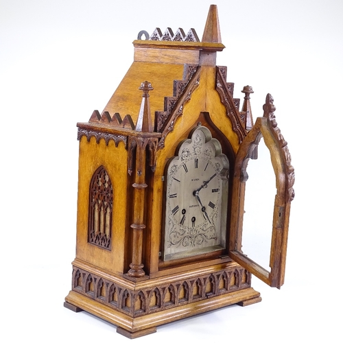 333 - A Victorian Gothic light oak-cased bracket clock, with elaborately carved architectural case with co... 