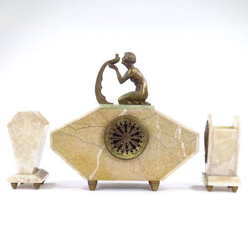 345 - A French Art Deco alabaster and onyx-cased clock garniture, surmounted by a gilt-metal figure of a g... 