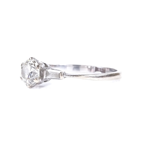 388 - A 0.7ct solitaire diamond ring, 18ct white gold settings with tapered baguette-cut diamond shoulders... 