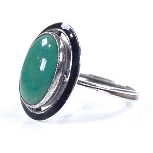 393 - An Art Deco sterling silver green stone and black enamel panel ring, with pierced settings and close... 