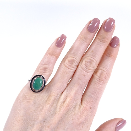 393 - An Art Deco sterling silver green stone and black enamel panel ring, with pierced settings and close... 