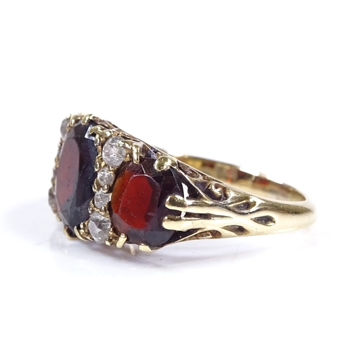 397 - A large 18ct gold garnet and diamond half-hoop ring, with pierced scrollwork bridge, setting height ... 