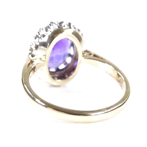 401 - A 9ct gold oval-cut amethyst and diamond cluster ring, setting height 13mm, size L, 3.3g