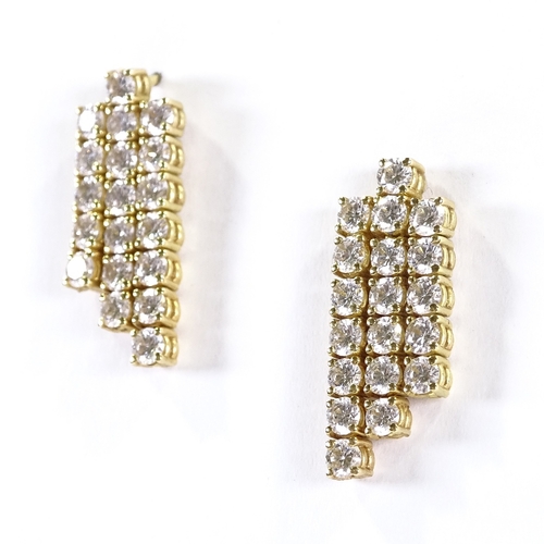 403 - A pair of unmarked gold triple-row diamond earrings, each set with 19 round brilliant-cut diamonds, ... 