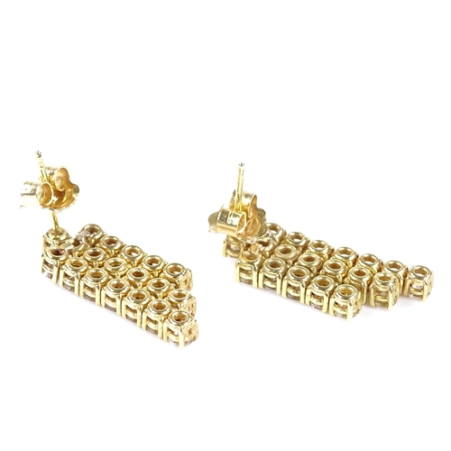 403 - A pair of unmarked gold triple-row diamond earrings, each set with 19 round brilliant-cut diamonds, ... 