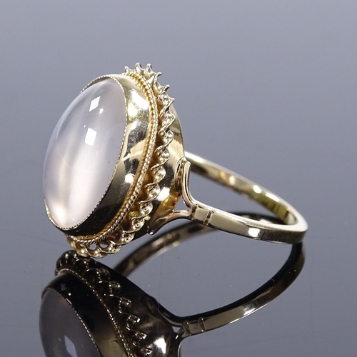 417 - A 9ct gold cat's eye cabochon moonstone ring, with rope twist surround, setting height 17.6mm, size ... 