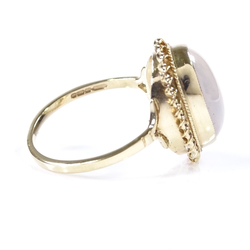 417 - A 9ct gold cat's eye cabochon moonstone ring, with rope twist surround, setting height 17.6mm, size ... 