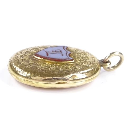 424 - A Victorian 9ct gold locket pendant, with intaglio carved shield-shaped sardonyx seal, within a flor... 